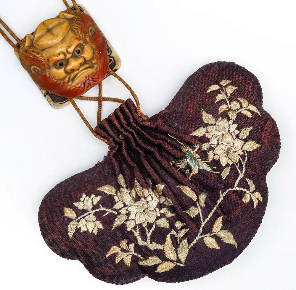 Appraisal: A JAPANESE EMBROIDERED PURSE WITH MYTHICAL MASK SLIDE The silk