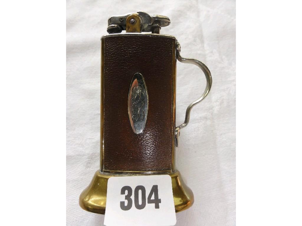 Appraisal: A brass and leather cigarette lighter of stylised form by