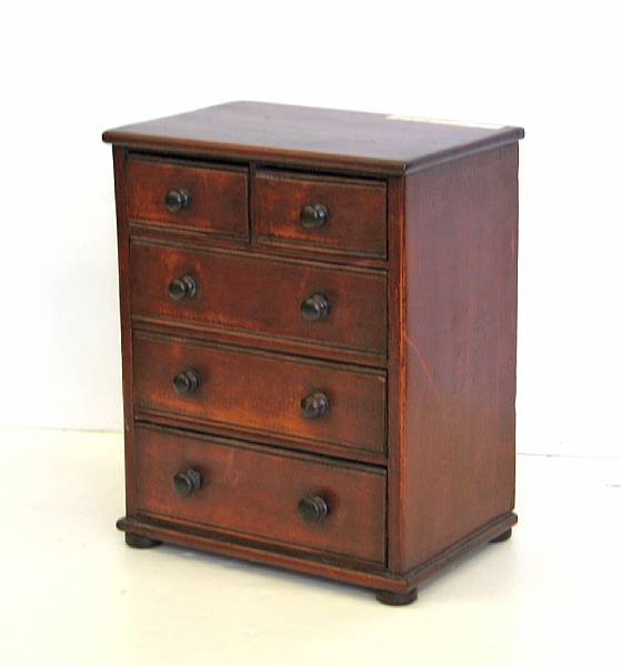 Appraisal: A Victorian miniature stained pine chest of drawers late th