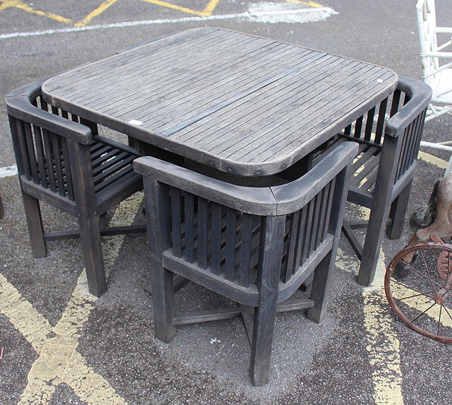 Appraisal: A TEAK GARDEN TABLE SET BY CASSELLS SHIP BREAKING LTD