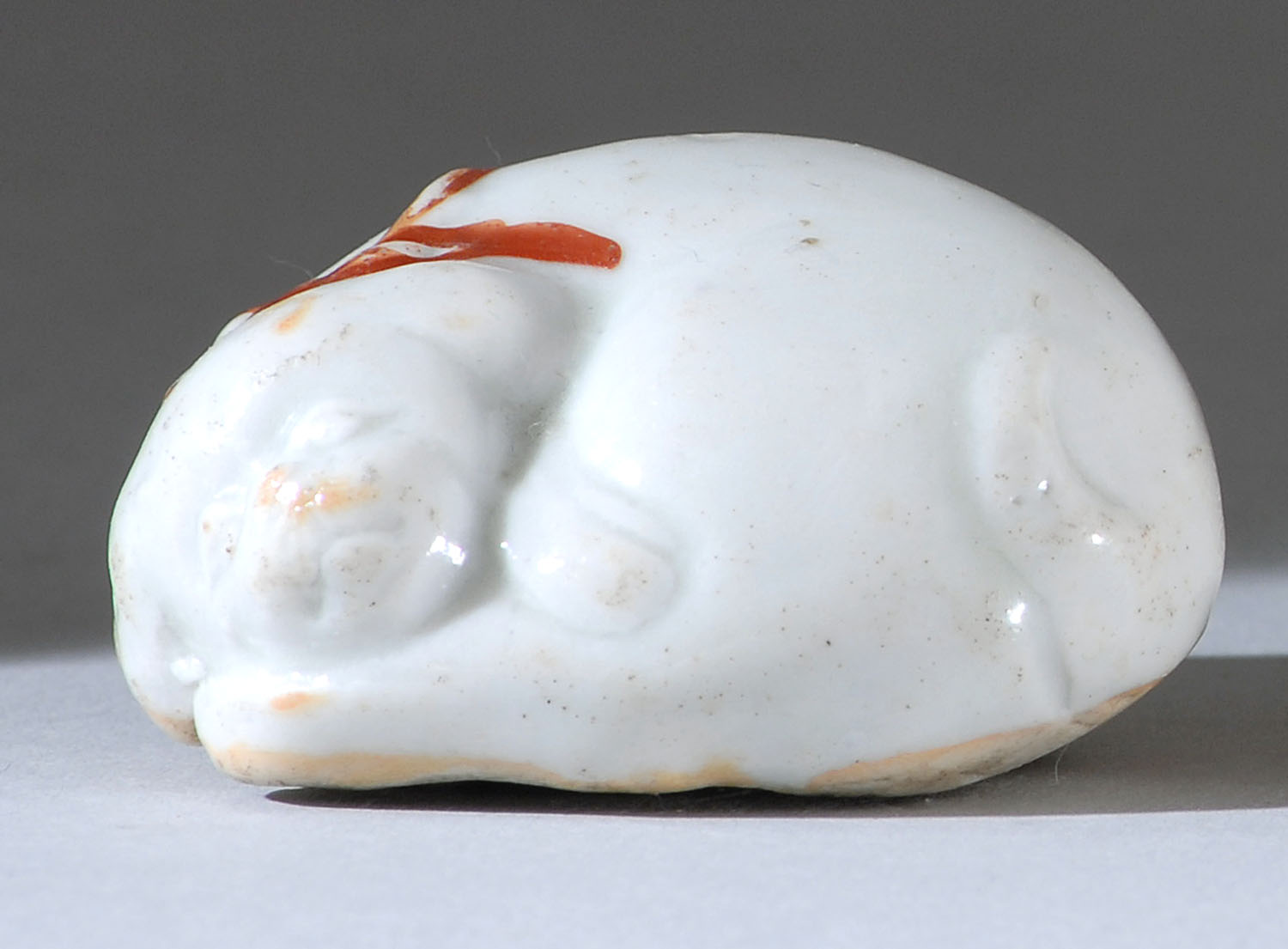 Appraisal: PORCELAIN NETSUKE Early th CenturyIn the form of a sleeping