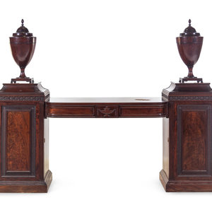 Appraisal: An Edwardian Carved and Figured Mahogany Double Pedestal Sideboard and