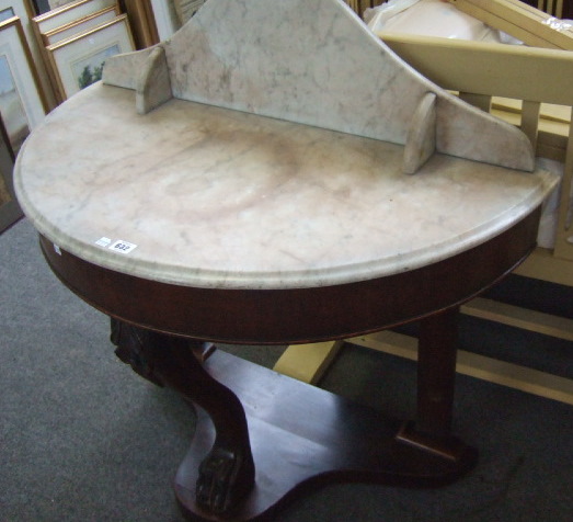 Appraisal: A Victorian marble topped demi-lune wash stand raised on single