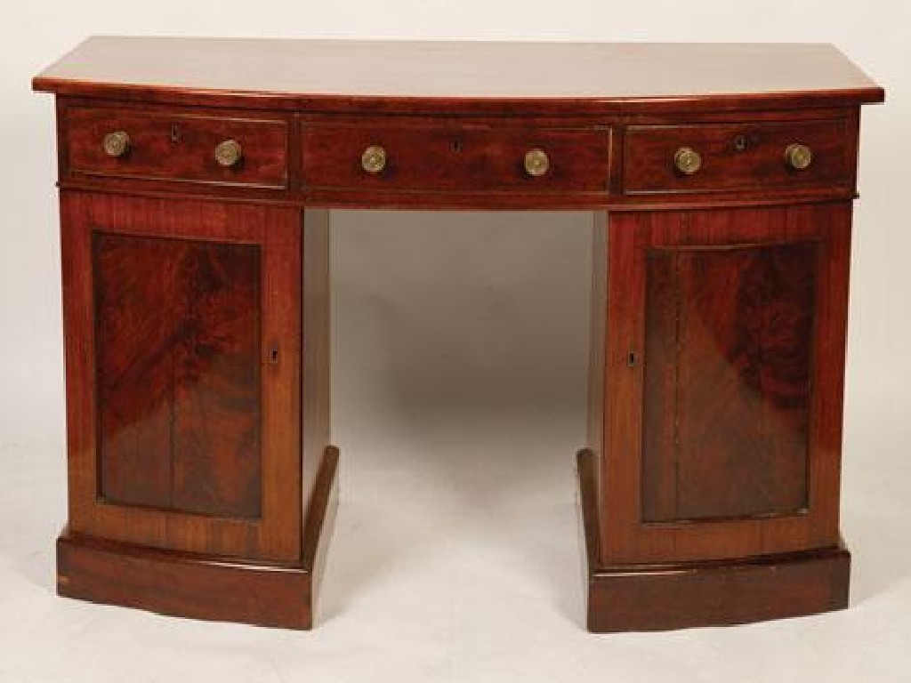 Appraisal: A REGENCY MAHOGANY BOW FRONTED SIDEBOARD the top above three