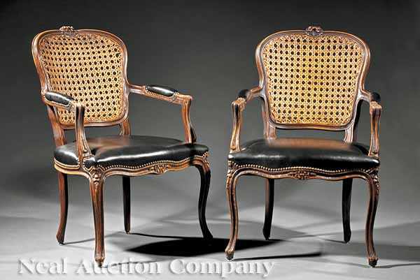 Appraisal: A Pair of French Carved Mahogany Fauteuils shaped caned backs