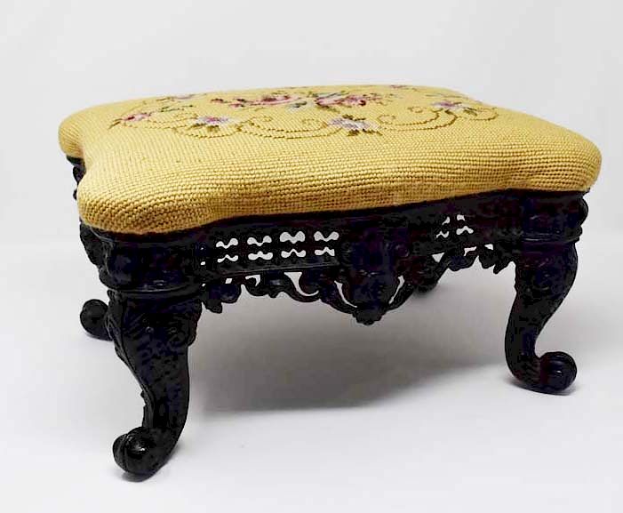 Appraisal: Footstool with ornate cast iron frame Footstool with ornate cast