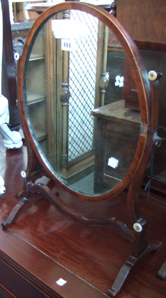 Appraisal: A mahogany framed skeleton swing framed toilet mirror together with