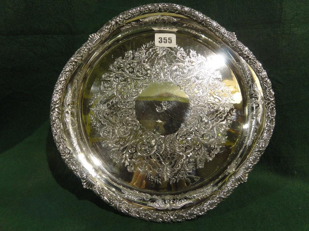 Appraisal: A circular silver salver with heavily engraved rim and all