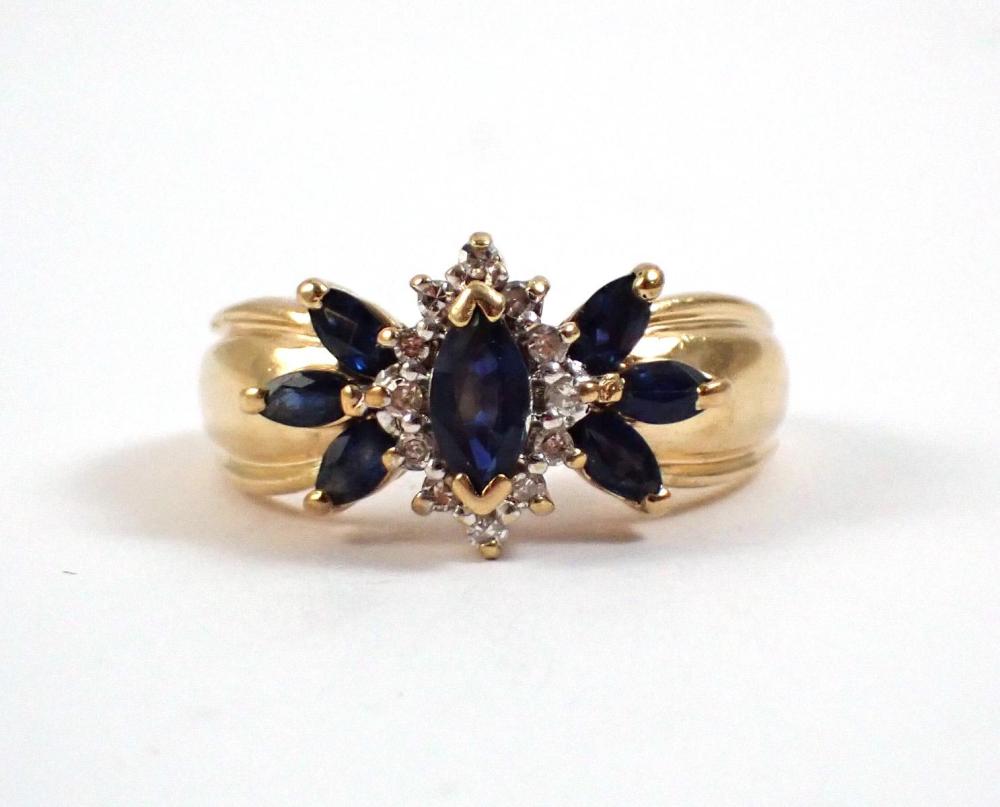 Appraisal: DIAMOND BLUE SAPPHIRE AND FOURTEEN KARAT GOLD RING seven marquise-cut