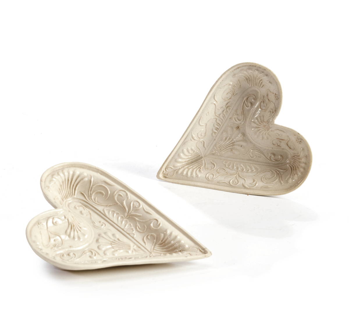 Appraisal: TWO STAFFORDSHIRE SALTGLAZE HEART-SHAPED SWEETMEAT DISHES CIRCA - Each elaborately