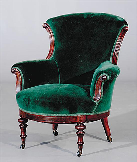 Appraisal: Victorian upholstered mahogany armchair shaped and molded frame on turned