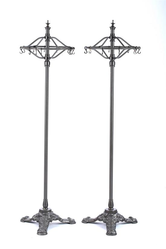 Appraisal: PAIR PEWTER FINISH ROUND-TOP GARMENT RACKS th century Finial topped