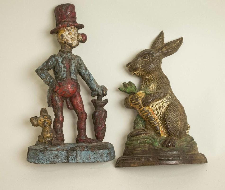 Appraisal: Two Cast Iron Doorstops Two cast iron figural doorstops Tallest