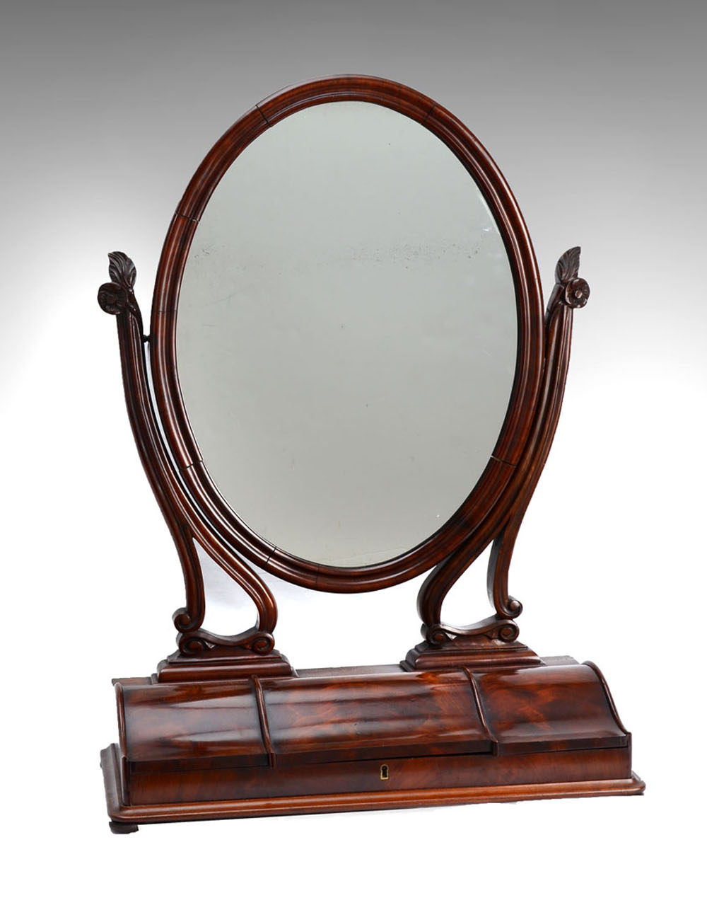 Appraisal: MEN'S MAHOGANY DRESSING MIRROR Oval articulated mirror supports with carved