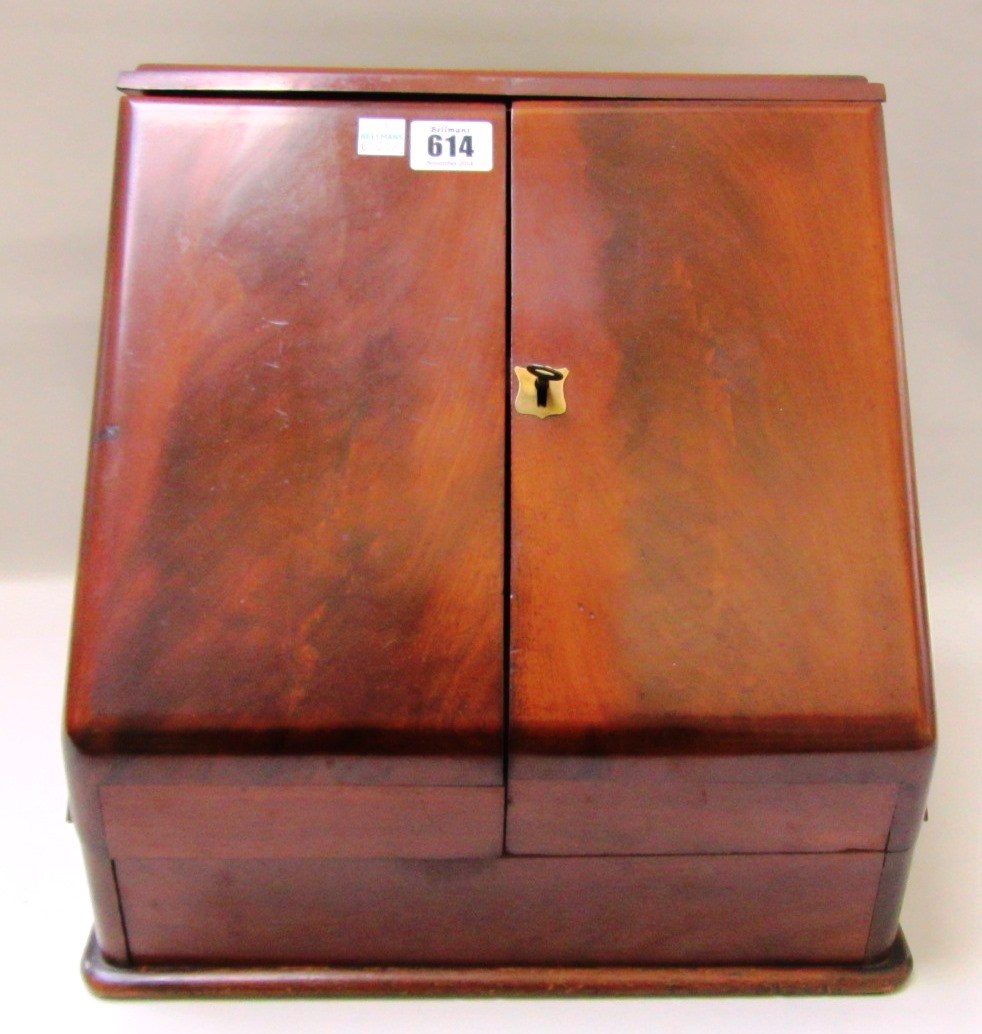 Appraisal: A th century mahogany slope front stationery box with fitted