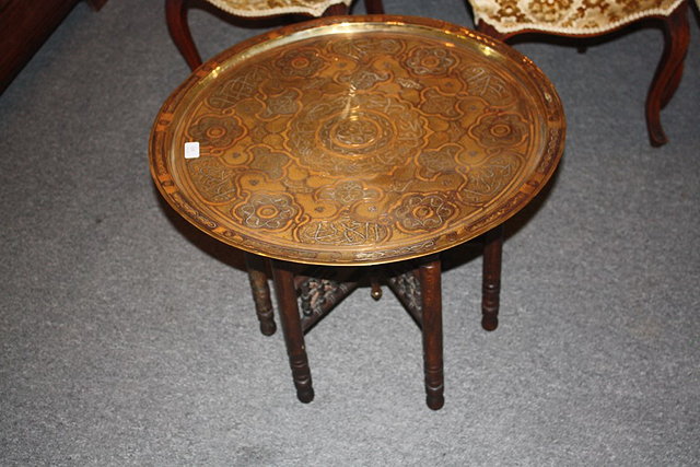 Appraisal: AN EGYPTIAN BRASS CIRCULAR TRAY on a folding stand the