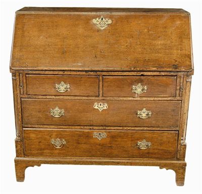 Appraisal: A George III oak bureau the hinged fall enclosing pigeon