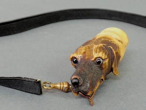 Appraisal: Carved bone dog head whistle with glass eyes probably late