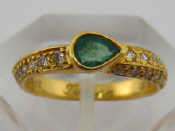 Appraisal: A pear shape emerald and diamond ring marked and unascribed