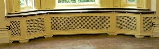 Appraisal: A pierced cast radiator surround with five panels and a