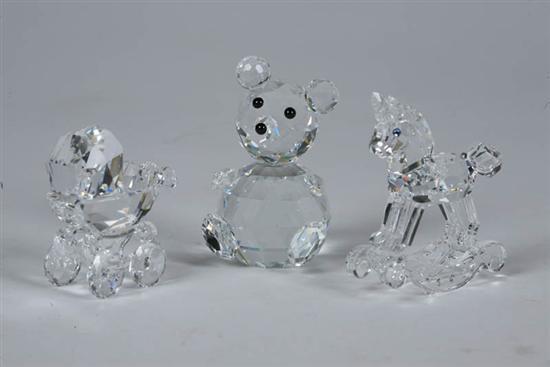 Appraisal: THREE SWAROVSKI FIGURES Teddy bear h Rocking horse h Baby