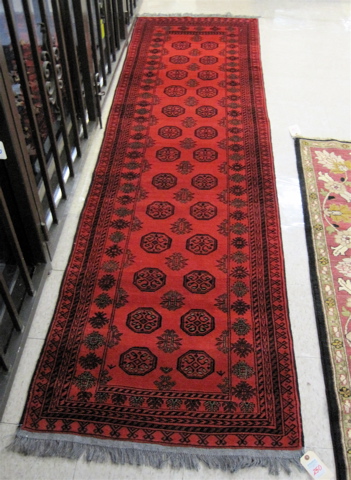 Appraisal: AFGHANI BOKHARA RUNNER featuring two columns of octagons on crimson