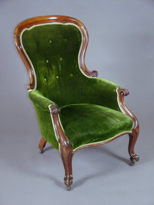 Appraisal: A Victorian mahogany spoon back armchair the scroll arms above