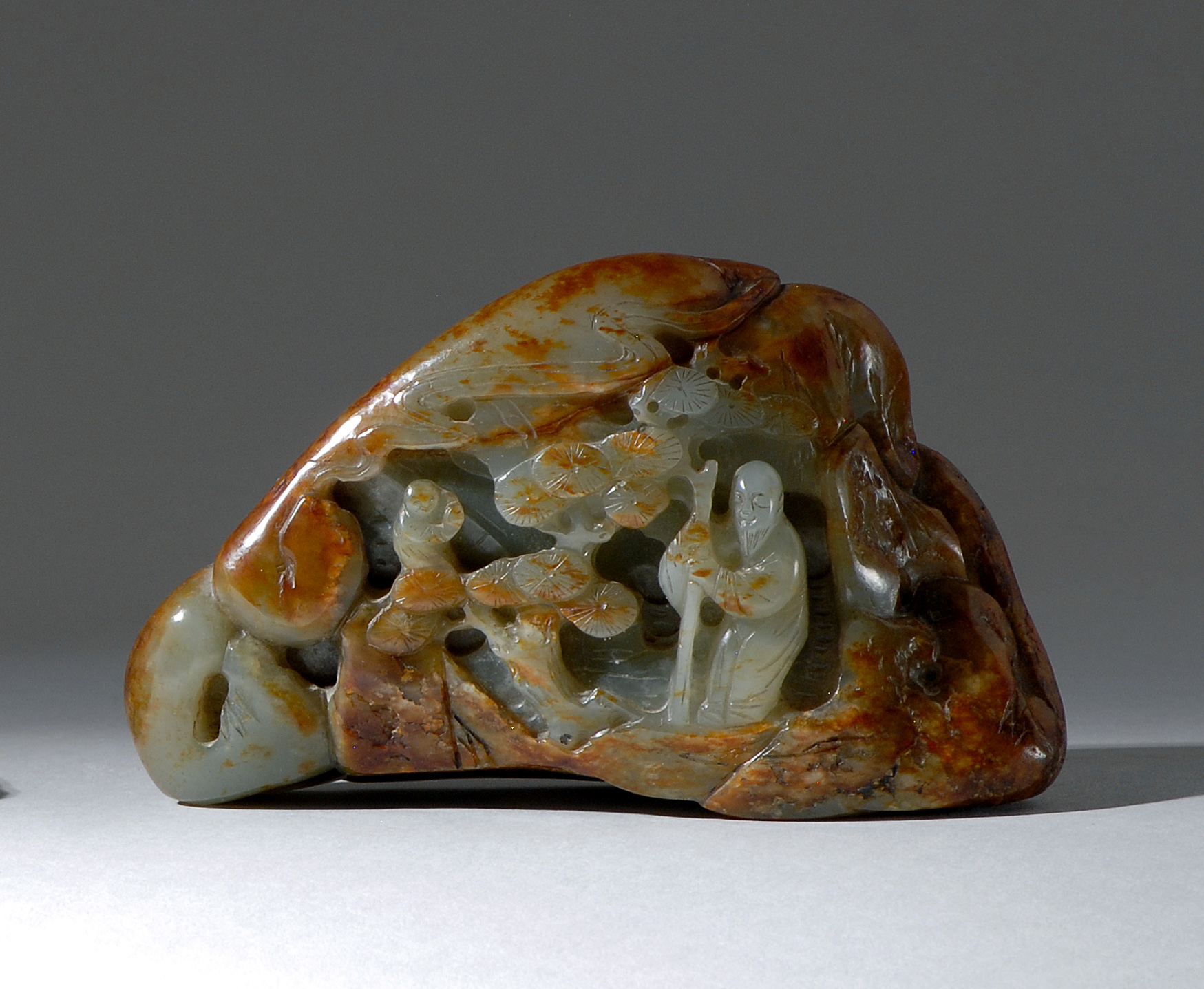 Appraisal: CELADON AND RUSSET JADE MOUNTAIN th CenturyWith high-relief carving of