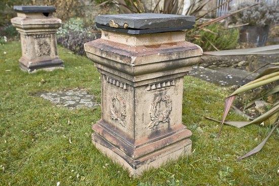 Appraisal: A pair of rectangular Coade stone type plinths with stepped