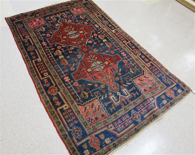 Appraisal: SEMI-ANTIQUE PERSIAN TRIBAL AREA RUG double geometric red medallion and