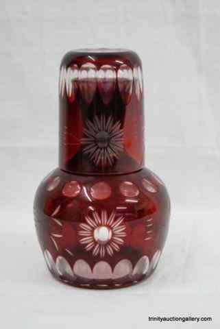 Appraisal: Ruby Cut To Clear Bohemian Tumble Up Decanter SetProduced and