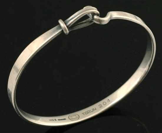 Appraisal: A silver bangle by Georg Jensen Designed by Torun of