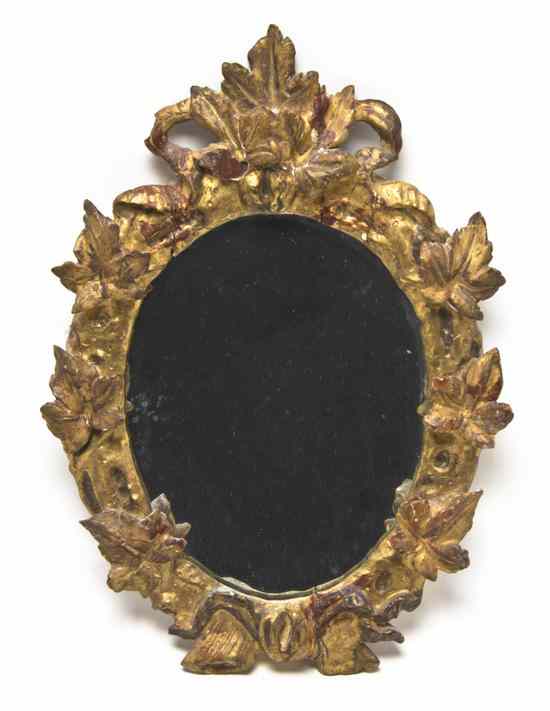 Appraisal: An Italian Giltwood Mirror having a ribbon-tied foliate crest over