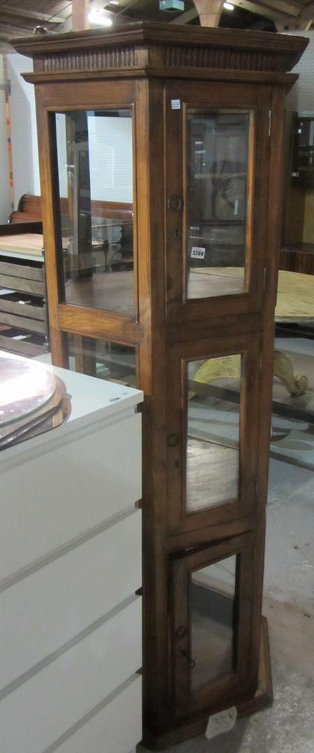 Appraisal: A hexagonal hardwood display cabinet