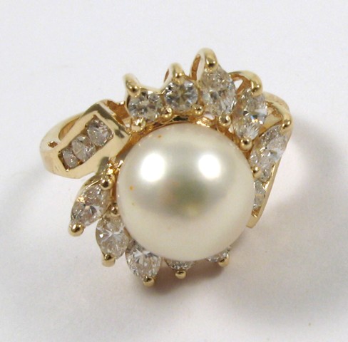 Appraisal: PEARL AND FOURTEEN KARAT GOLD RING centering an mm round