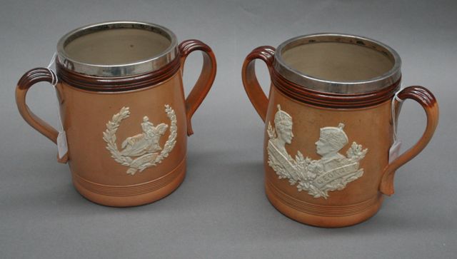 Appraisal: Two Royal Doulton salt glazed stoneware loving cups commemorating the