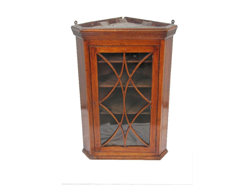 Appraisal: An early th century oak hanging corner cupboard with astragal