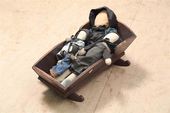 Appraisal: FOUR DOLLS AND CRADLE Three cloth one leather A woman