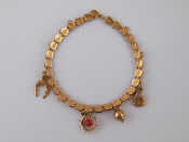 Appraisal: A yellow metal tests carat gold charm bracelet charms untested