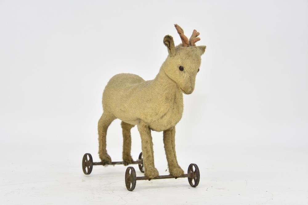 Appraisal: Vintage mohair steiff deer on metal wheels with original ear