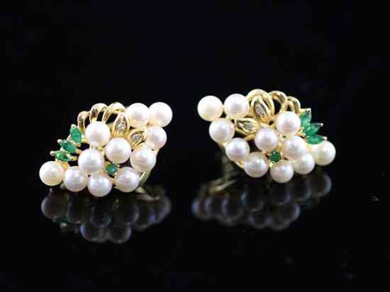 Appraisal: A pair of gold diamond emerald and cultured pearl clip