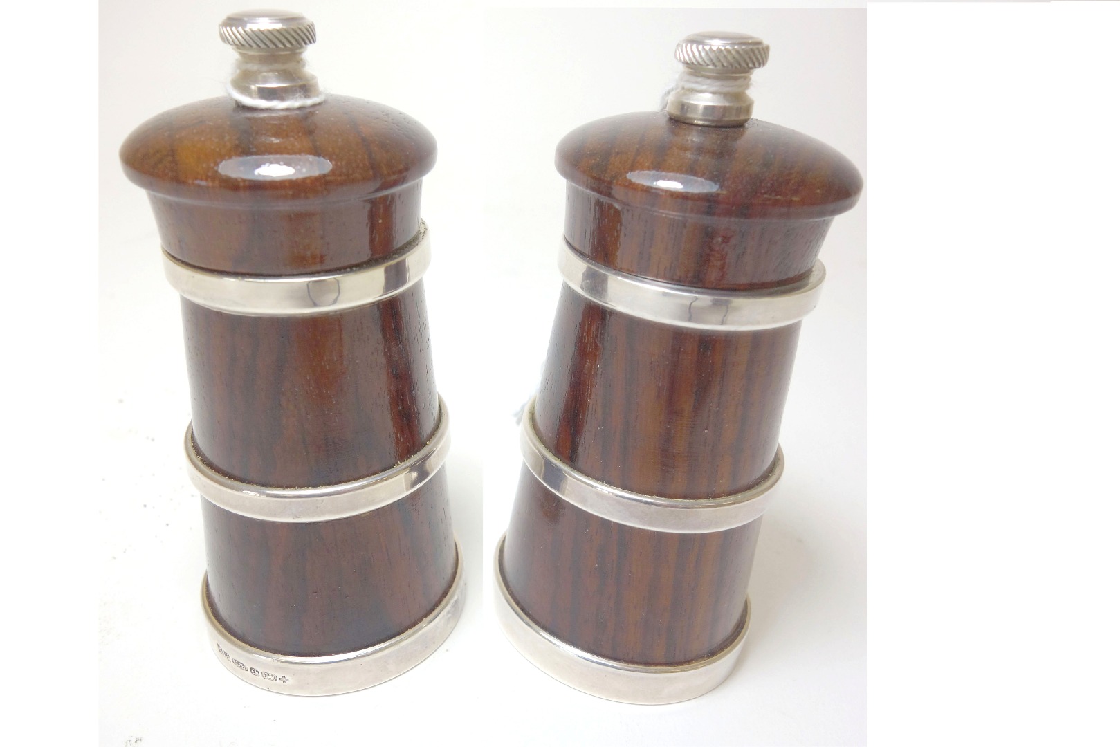 Appraisal: A pair of modern silver mounted rosewood capstan pepper mills