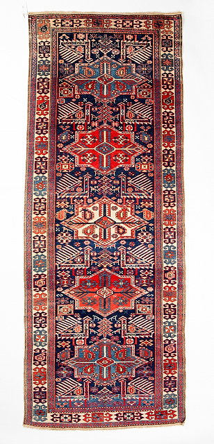 Appraisal: A CAUCASIAN POLYCHROME RUNNER with stylised winged motifs on an