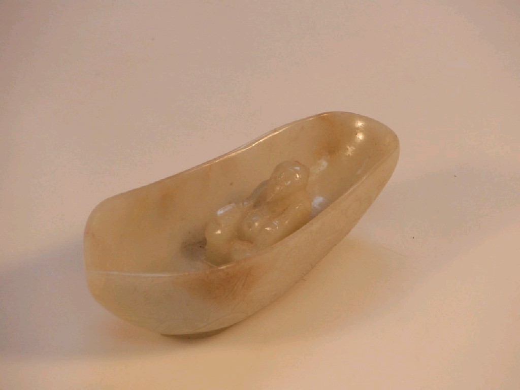 Appraisal: A jade figure of a immortal in a boat shaped