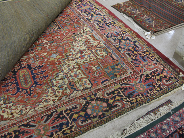 Appraisal: SEMI-ANTIQUE PERSIAN HERIZ CARPET central geometric medallion and stylized floral