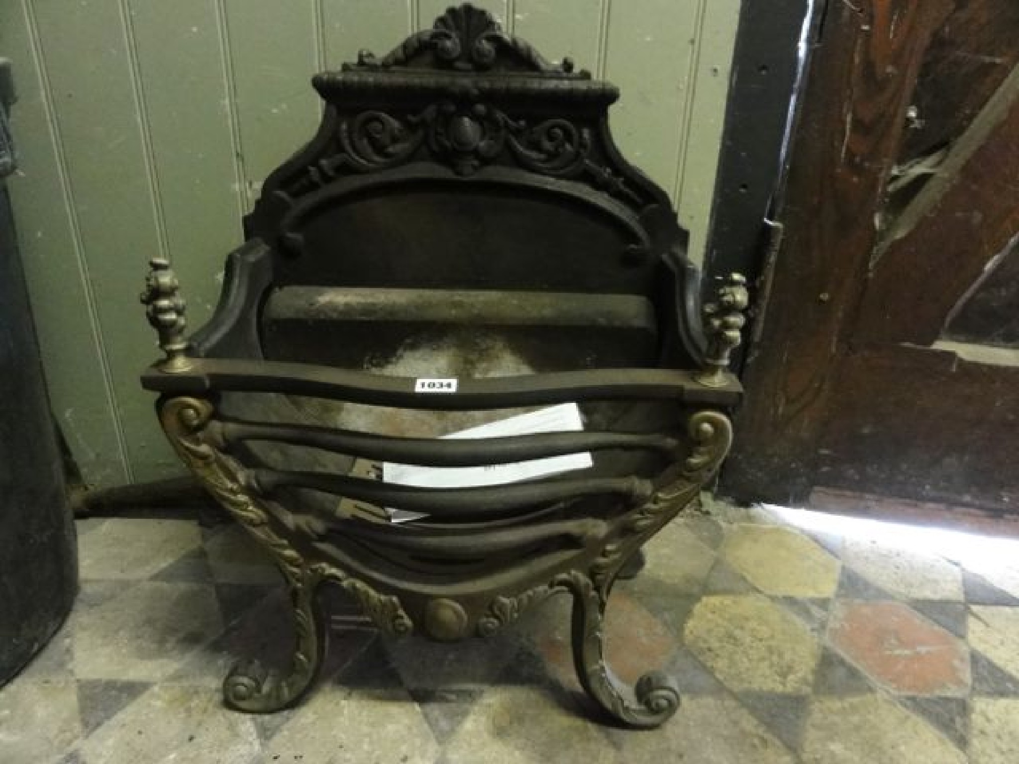 Appraisal: A small Regency style cast iron and brass fire basket