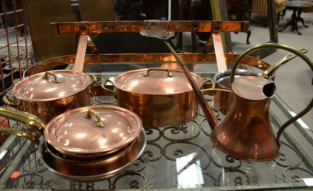 Appraisal: Group of eight copper and brass handled cookware center island