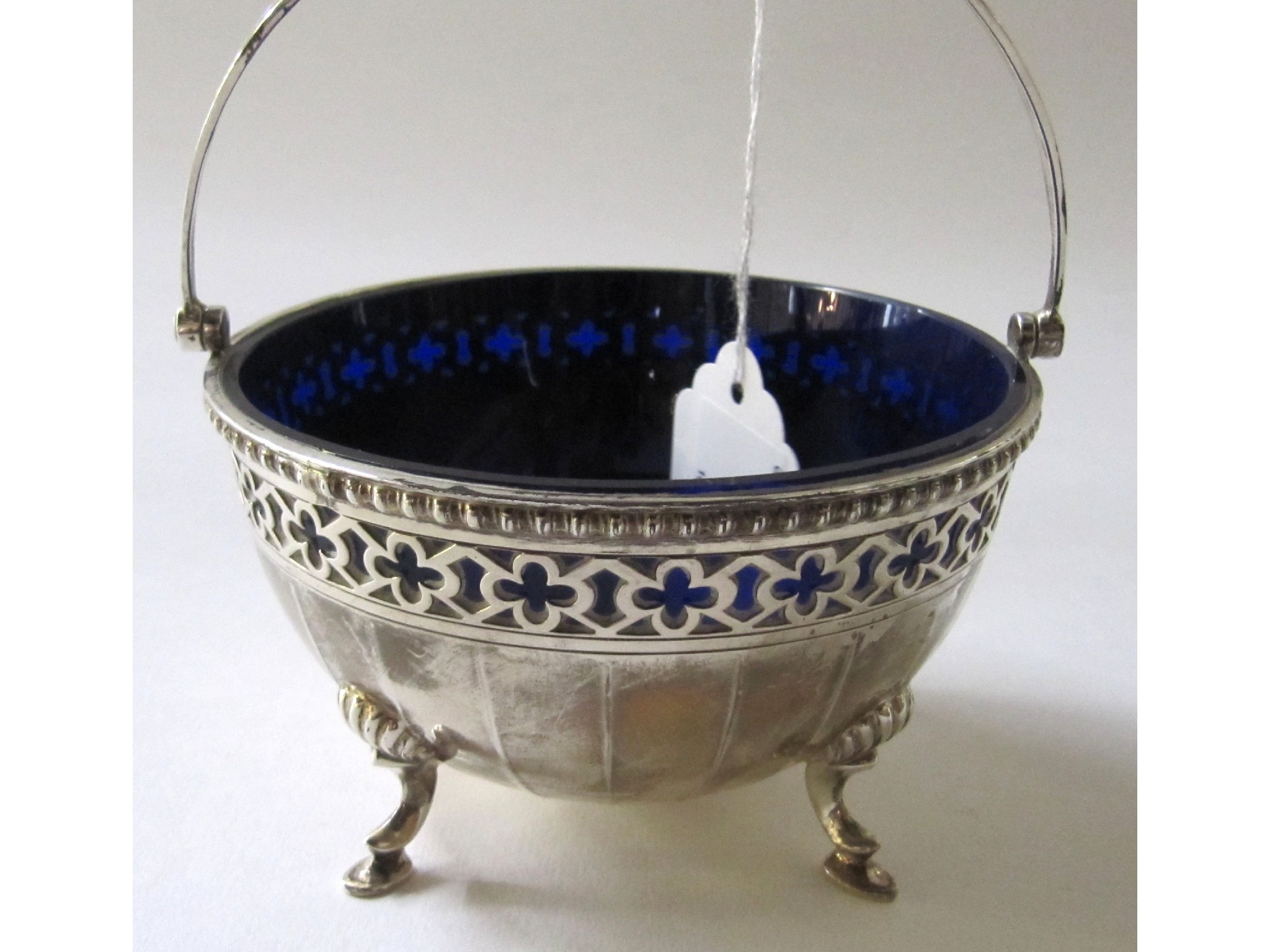 Appraisal: A silver sugar basket with blue glass liner Birmingham