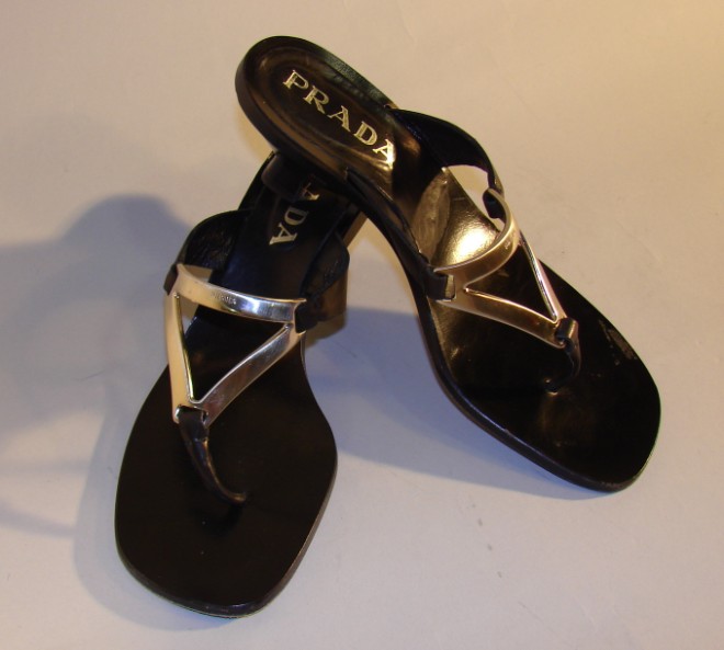 Appraisal: Sandals have a metal pewter finish triangle front with the