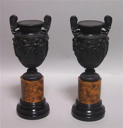 Appraisal: PAIR OF SMALL BLACK URNS AFTER THE ANTIQUE The urns